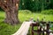 Rustic wedding table for two in the field at the pine tree. Chairs and honeymooners table decorated