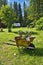 Rustic wheelbarrow with plants in a garden