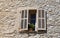 Rustic window with old wood shutters in stone rural house, Prove