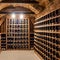 A rustic wine cellar with wooden racks, a tasting area, and dimmed lighting1, Generative AI