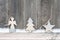 Rustic winter background with wooden figures star, Christmas tree and angel with snow on wooden texture. Christmas and New Year