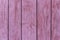 Rustic wood texture or background with scratched pink paint