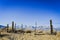 Rustic wood and wire fence in arid valley with distant snowy mountains