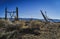 Rustic wood and wire fence in arid valley with distant snowy mountains