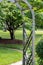 Rustic wooden arbor with vines, in a landscaped garden