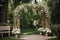 rustic wooden archway, decorated with vines and flowers for elegant wedding