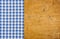 Rustic wooden background with a blue checkered tablecloth