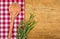 Rustic wooden background with checkered tablecloth