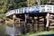 Rustic wooden bridge over river in forest