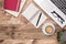 Rustic wooden desk top view with notebook, pen, laptop and coffee cup. Workspace with copy space. Office work, study or writing