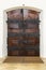Rustic wooden door with ornate hinges