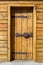 Rustic wooden fortress door with old iron latch