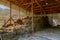 Rustic wooden hay storage building with an attic. Barn interior in the village. Rustic background