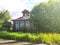 Rustic wooden house with a mezzanine on a sunny lawn