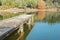 Rustic wooden pier leading int water of small lake