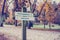 Rustic wooden sign in an autumn park with the words Professional