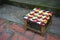 Rustic wooden stool with colorful woven seat on the street in Luang Prabang, Laos