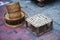 Rustic wooden stool with woven bamboo seat next to traditional sticky rice baskets in Luang Prabang, Laos