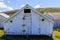 Rustic wooden storage shed painted white on historic Pierce Point Ranch
