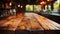 A rustic wooden table with a rich grain, set against a softly blurred kitchen background, exuding a warm, homely ambiance