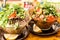 Rustic wooden table with two sets of dinner plates with a bowl of steaming soup