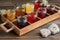 rustic wooden tray with assortment of jams, jellies, and preserves