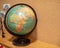 Rustic world globe displaying Africa and Europe in a child`s room