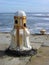 Rusting capstan on sea wall