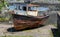 Rusting derelict boat left on a beach