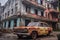 rusting vintage car parked in front of a dilapidated building