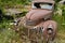 A rusty 1943 Chevy truck overgrown with weeds in a junkyard in Idaho, USA - July 26, 2021