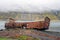 Rusty and abandoned old ship wreck from world war two laying on land in Mjoifjordur in Iceland.