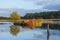 Rusty, abandoned ship in a little lake, surrounded by meadows,