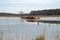 Rusty, abandoned ship in a little lake in winter, surrounded by meadows,