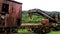 Rusty and abandoned waggon out of the railroad. The rotten waggon is located at a tropical forest