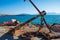 Rusty anchor on the shore at Aegina harbour in Greece