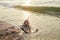 RUSTY ANCHOR WET BEACH SAND AND WHITE SEA WAVE FOAM