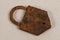 Rusty antique padlock removed from the ground.