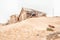 Rusty bathtub and ruins on a dune at Kolmanskop