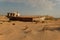 Rusty boat shell lying in the desert