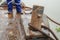 Rusty bollard of barge with rope under damage inspection of the technical engineer