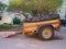 Rusty car trailer with two wheel axle