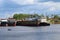 Rusty cargo ships and lonely fisherman on boat on summer