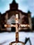 rusty Catholic cross on a blurry background