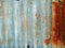 A rusty corrugated iron metal fence