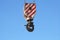 Rusty crane hook hanging on blue sky