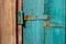 Rusty Door hinge on blue painted wood door with cracked and scratch. Horizontal grunge texture