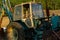 Rusty excavator working in countryside. Weathered excavator digging ground during agricultural works in field on summer