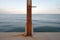 Rusty flag pole at the sea edge