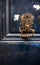 Rusty forged metal door handle with a patterned base on a dark blue old flaky front door